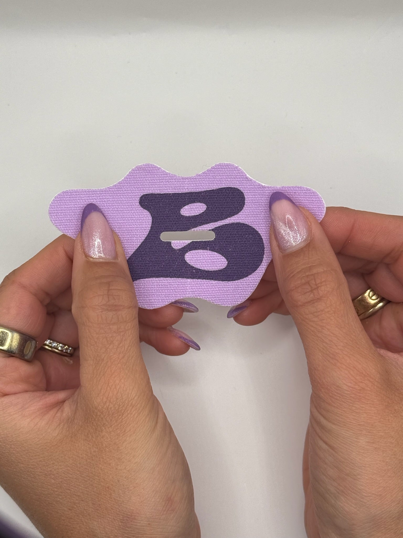 Holding Bedrock lilac mouth tape with premium silk material for deep sleep, better energy, and natural breathing support.